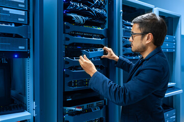 Wall Mural - Man fixing server in data center room .