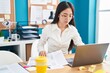 © Krakenimages.com - Young chinese woman business worker using laptop reading document at office