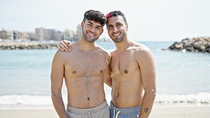 Wall Mural - Two men tourist couple smiling confident hugging each other at beach