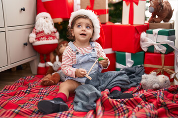 Sticker - Adorable hispanic girl smiling confident sitting on floor by christmas tree at home