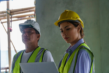 women civil engineers and foreman Inspecting the building during construction inside construction site