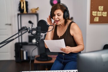 Poster - Middle age woman musician smiling confident singing song at music studio