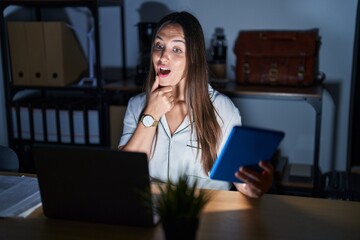 Sticker - Young brunette woman working at the office at night looking confident at the camera smiling with crossed arms and hand raised on chin. thinking positive.