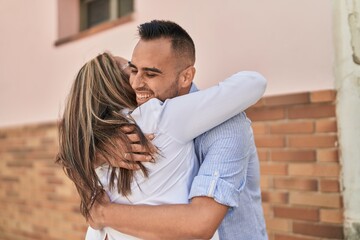 Canvas Print - Man and woman mother and daugther hugging each other at street