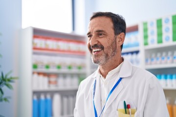 Sticker - Middle age man pharmacist smiling confident standing at pharmacy