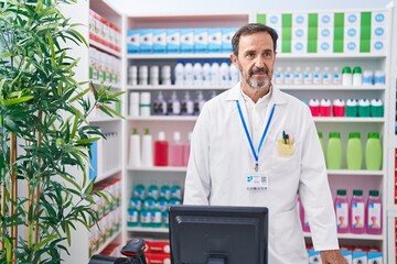 Wall Mural - Middle age man pharmacist standing with relaxed expression at pharmacy