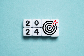 Wall Mural - 2024 year with dartboard arrow on white cube for setup business objective target and investment goal
