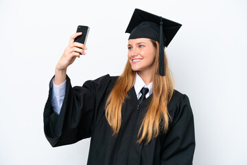 Wall Mural - Young university graduate caucasian woman isolated on white background making a selfie