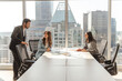 © Maria Vitkovska - Smiling business people working in modern office, talking, cooperation, sharing ideas