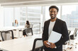 © Maria Vitkovska - Handsome successful businessman holding laptop and smiling at camera