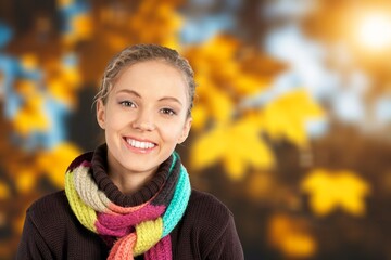 Wall Mural - Young woman in autumn park with foliage leaves