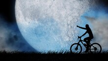 Silhouette Of A Girl Riding A Bicycle Against The Background Of A Blue Moon. She Raises Her Hand Triumphantly.