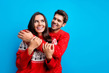 Wall Mural - Photo portrait of attractive young couple embrace have fun dating wear x-mas ornament red sweaters isolated on blue color background