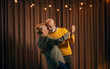 A romantic senior couple is dancing together.