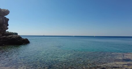 Wall Mural - Time lapse video over the turquoise sea near Pula directly above the water surface