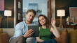 Unhappy spouses greeting tablet call at home zoom on. Sad woman waving hand pad
