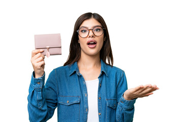 Wall Mural - Young Russian woman holding a wallet over isolated chroma key background with shocked facial expression