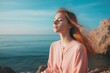 © Martin - A young woman finds serenity on a coastal rock, practicing mindfulness and focused breathing by the seashore, enhancing her mental well-being a breathwork concept that harmonizes mind,body, and spirit