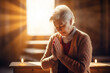 Elder woman pray in church Christian life crisis prayer to god. Hands praying to god with bible on sunlight glare