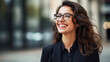 Cheerful professional business woman, happy laughing female office worker wearing glasses looking away at copy space advertising job opportunities or good business services.