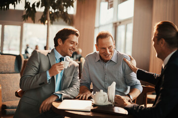 Wall Mural - Businessmen Engaged in Discussion Over Coffee