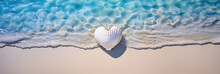 White Heart Shaped Seashell Lying In The Sand With The Blue Sea And Soft Waves In Background