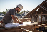 Fototapeta  - An architect scrutinizes building plans on a roof