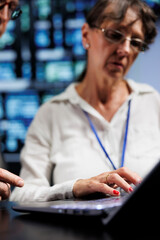 Poster - Cloud computing business executives working to maintain uptime in high tech space. Seasoned professionals brainstorming solutions to data center supercomputers crashing, trying to fix components