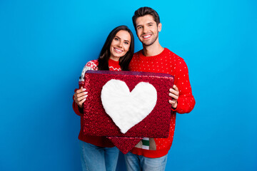 Sticker - Photo portrait of attractive young couple hold heart icon notification wear x-mas ornament red sweaters isolated on blue color background