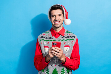 Poster - Photo portrait of nice young male instagram twitter facebook telegram wear x-mas print vest hat garment isolated on blue color background