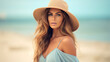 © Santy Hong - Beach portrait of Young beautiful woman in the pastel blue dress and brown hat on beach background.