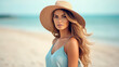 © Santy Hong - Beach portrait of Young beautiful woman in the pastel blue dress and brown hat on beach background.