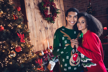 Wall Mural - photo of charming loving family couple wife husband celebrate christmas eve dance near illuminated pine tree indoors