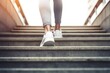 Closeup of female legs in sportswear walking up the stairs.

 Generative AI