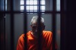© lee - Portrait of a man in an orange prison uniform behind bars. Generative AI