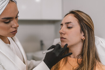 Wall Mural - Esthetician marking the face of a patient to inject Botox