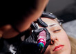 © Cherkasova Alie - The makeup artist performs permanent makeup. Professional makeup and facial care. Eyebrow and lip tattooing. Cosmetologist. Beauty salon.