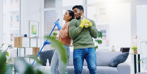 Sticker - Happy couple, dancing and singing while cleaning living room together for fun disinfection or hygiene at home. Man and woman enjoying housekeeping, germ and bacteria removal in lounge at house