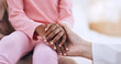 © Charlize D/peopleimages.com - Closeup, holding hands and doctor with girl, healthcare and wellness with comfort, diagnosis and support. People, medical and professional with a patient, compassion and empathy with paediatrician