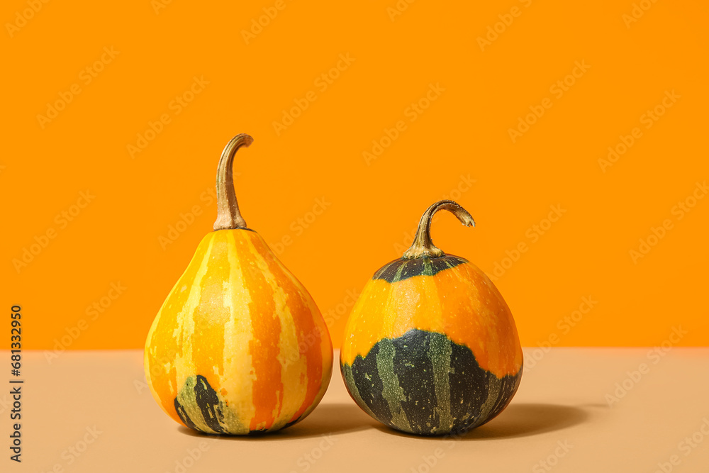 Fresh pumpkins on orange background