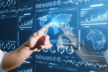 Poster - Close up of businessman hand pointing at glowing digital business charts and map interface on blurry background. Military control, warfare and spy concept.