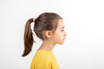 side view portrait of girl in yellow t-shirt, isolated on white background.