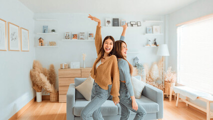 Loving couple enjoy dancing together in the living room a home. Homosexual-LGBTQ concept.