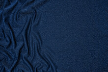 Trendy 80s, 90s, 2000s Background Of Draped Dark Blue Fabric With Silver Lurex Thread. Beautiful Fashionable Shiny Fabric With A Shiny Thread For Making Clothes. Textile Background Texture.