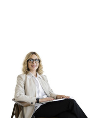 Wall Mural - The project manager is a woman using a laptop sitting in a chair in the office. The psychologist looks into the camera with glasses and smiles for the positive feedback.