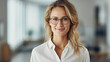 © Synthetica - Portrait of a smiling businesswoman in eyeglasses looking at camera.