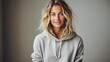 © Synthetica - Portrait of a beautiful young blonde woman in a gray hoodie.