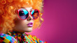 Close-up portrait of a fashionable young woman dressed in y2k style with large retro sunglasses, colourful shirt, make-up, wearing curly perm dyed orange, copy space.