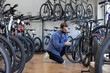 © ReeldealHD images - Adult male looking at electric bikes in a cycle store