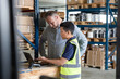 © ReeldealHD images - Employee in distribution warehouse being trained on paperwork to export products